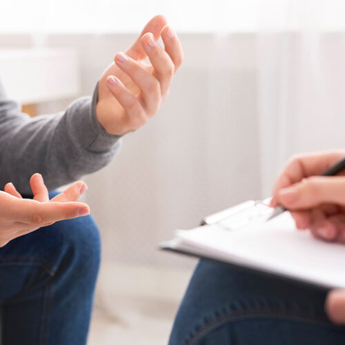 A man talks to an addiction treatment specialist about his treatment plan, one of the first steps of drug treatment.