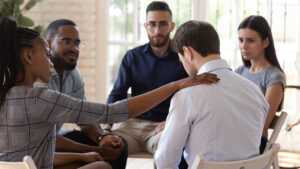 People participate in a 12-step meeting.