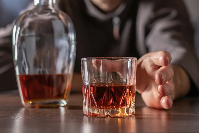 A person struggles with PTSD and alcohol addiction.