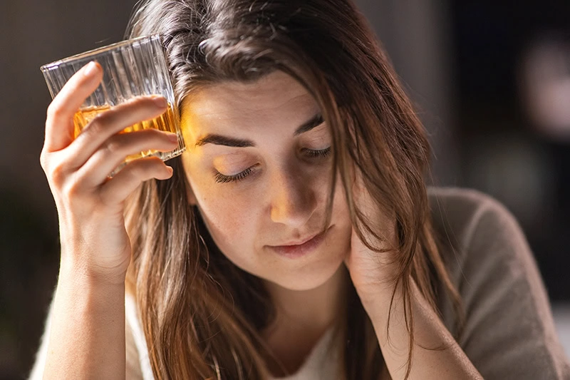 A woman struggles with PTSD and alcohol addiction.