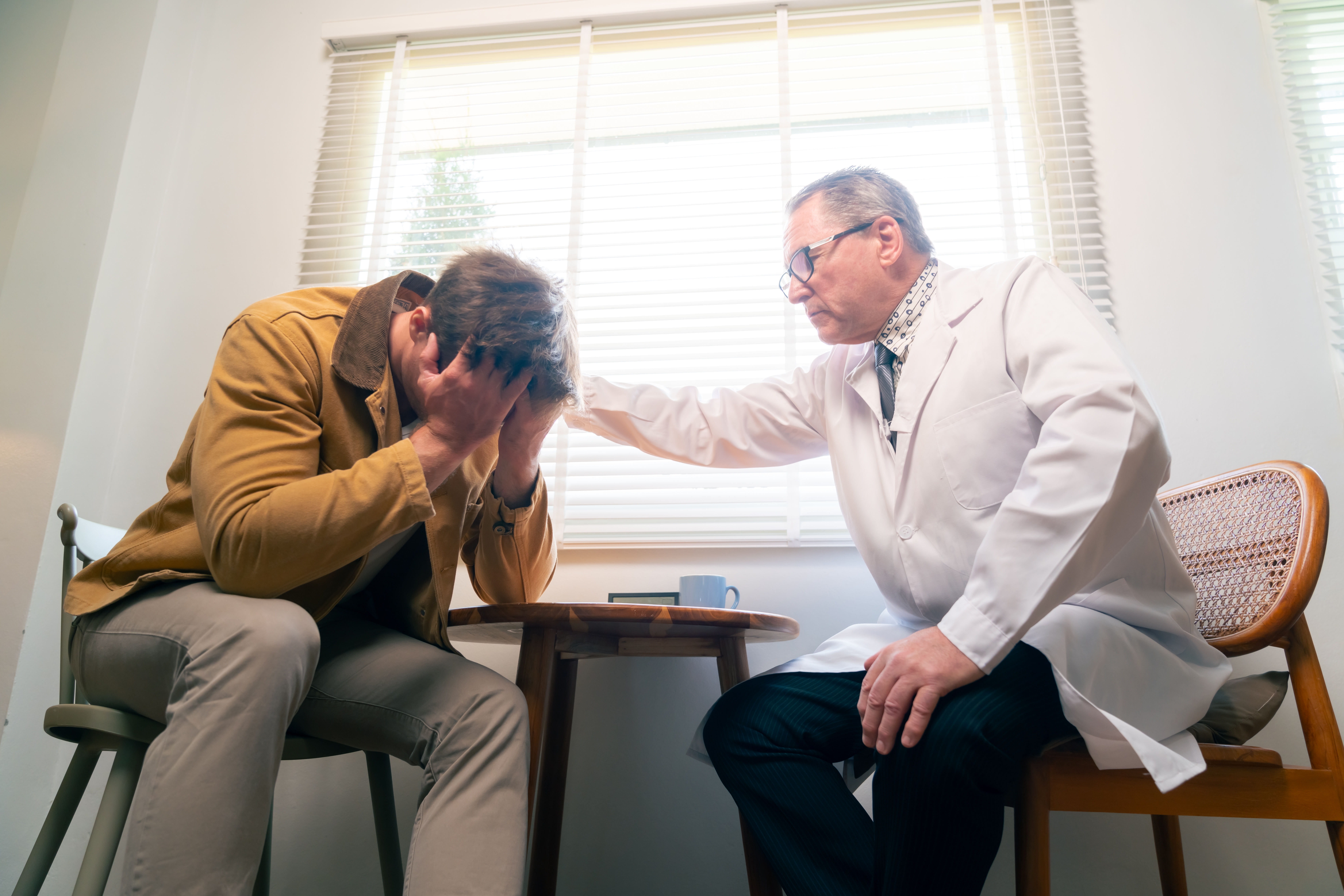 Upset man talking to his doctor about Is Zoloft Addictive?