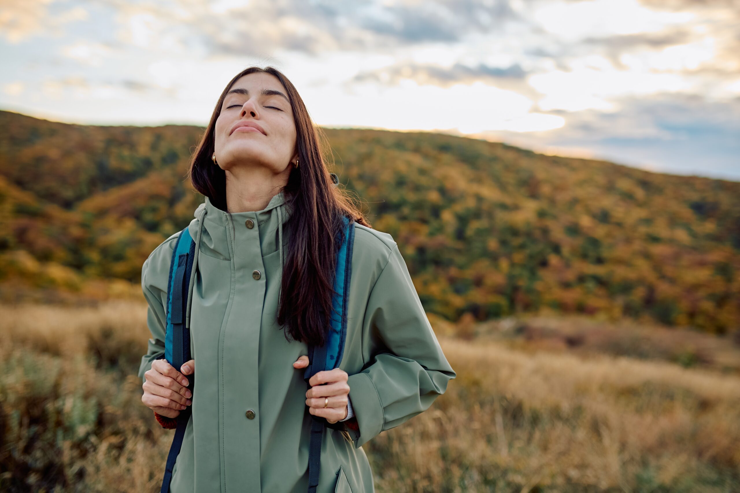 Woman outdoors discovering adventure therapy for treatment of substance use disorder.