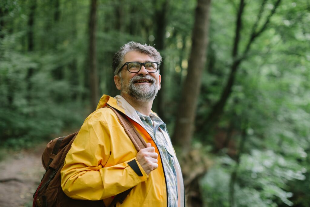 View of man smiling in forest near fentanyl addiction treatment in indiana.